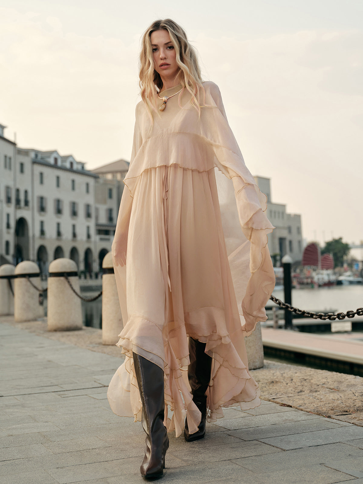 Front view of dress showing sheer chiffon overlay and floor-length hem