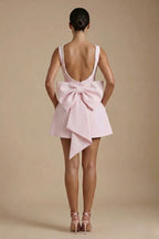 Fitted bodice and box-pleated skirt detail from side angle