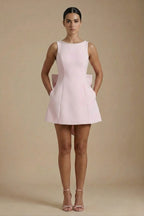 Women's pearl trim bow back mini dress, front view on model