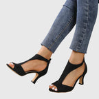 Peep toe sandal displayed on angled stand, three-quarter view