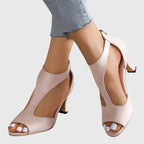 Women's blush pink peep toe block heel sandals with cutout detail, front view