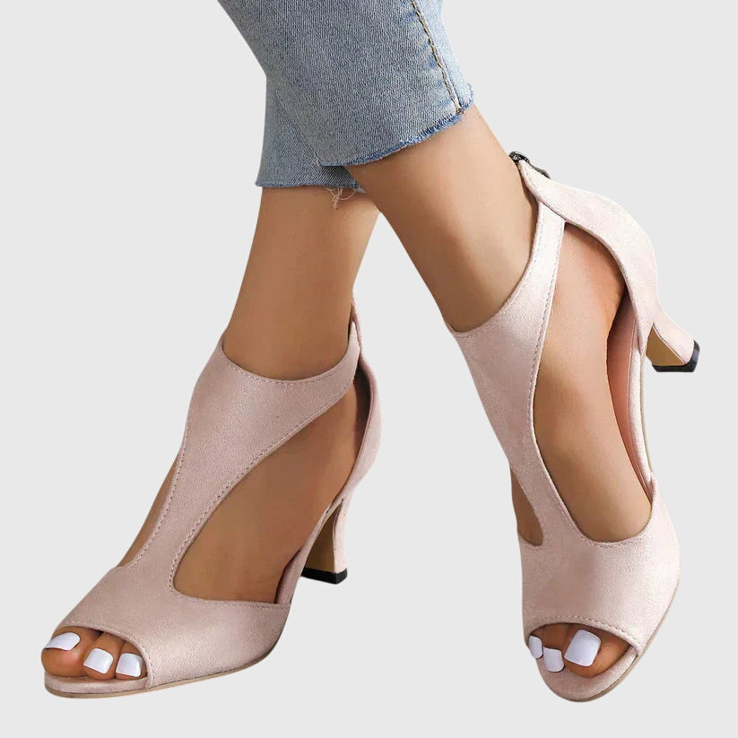 Women's blush pink peep toe block heel sandals with cutout detail, front view