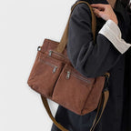Corduroy tote bag worn over shoulder while walking