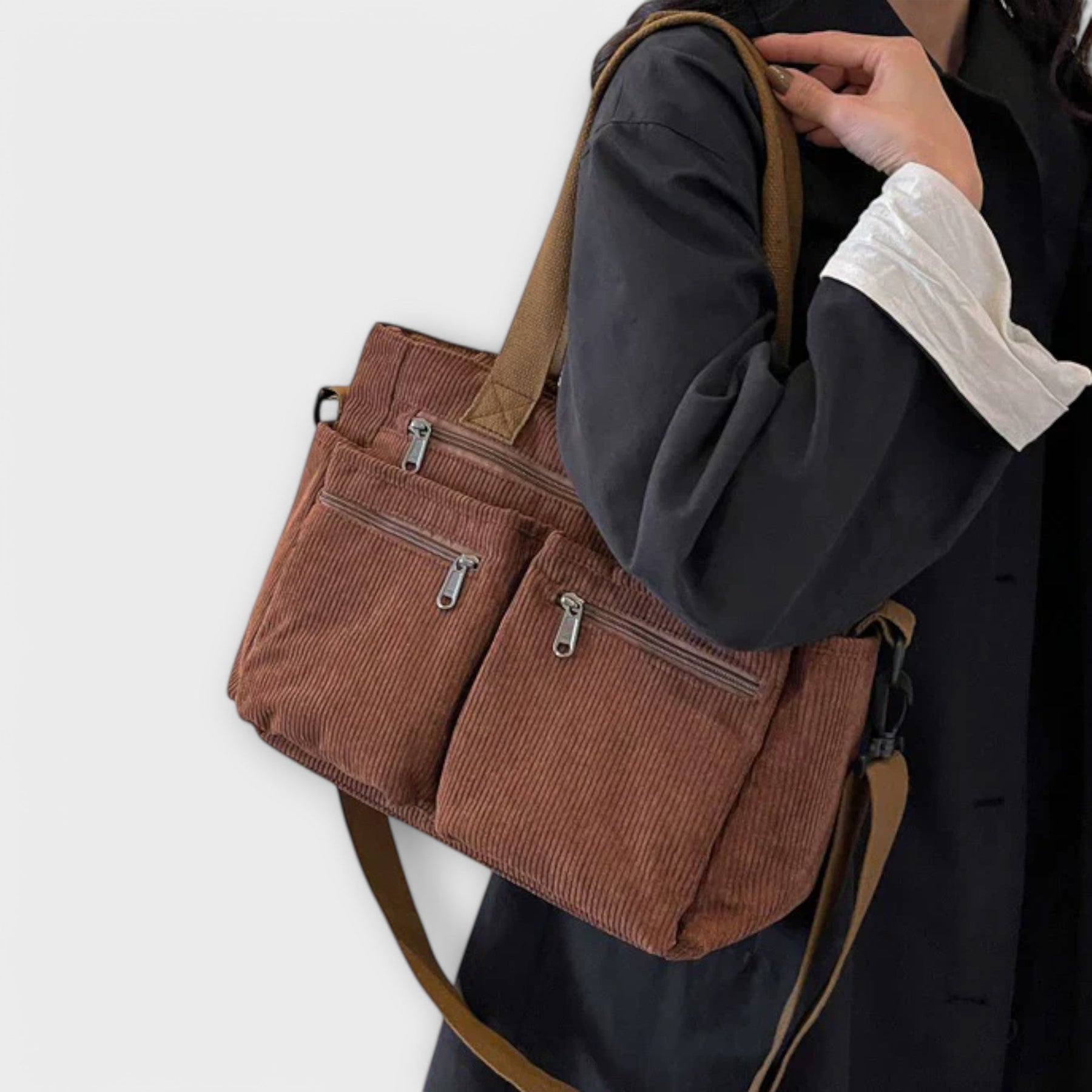 Corduroy tote bag worn over shoulder while walking