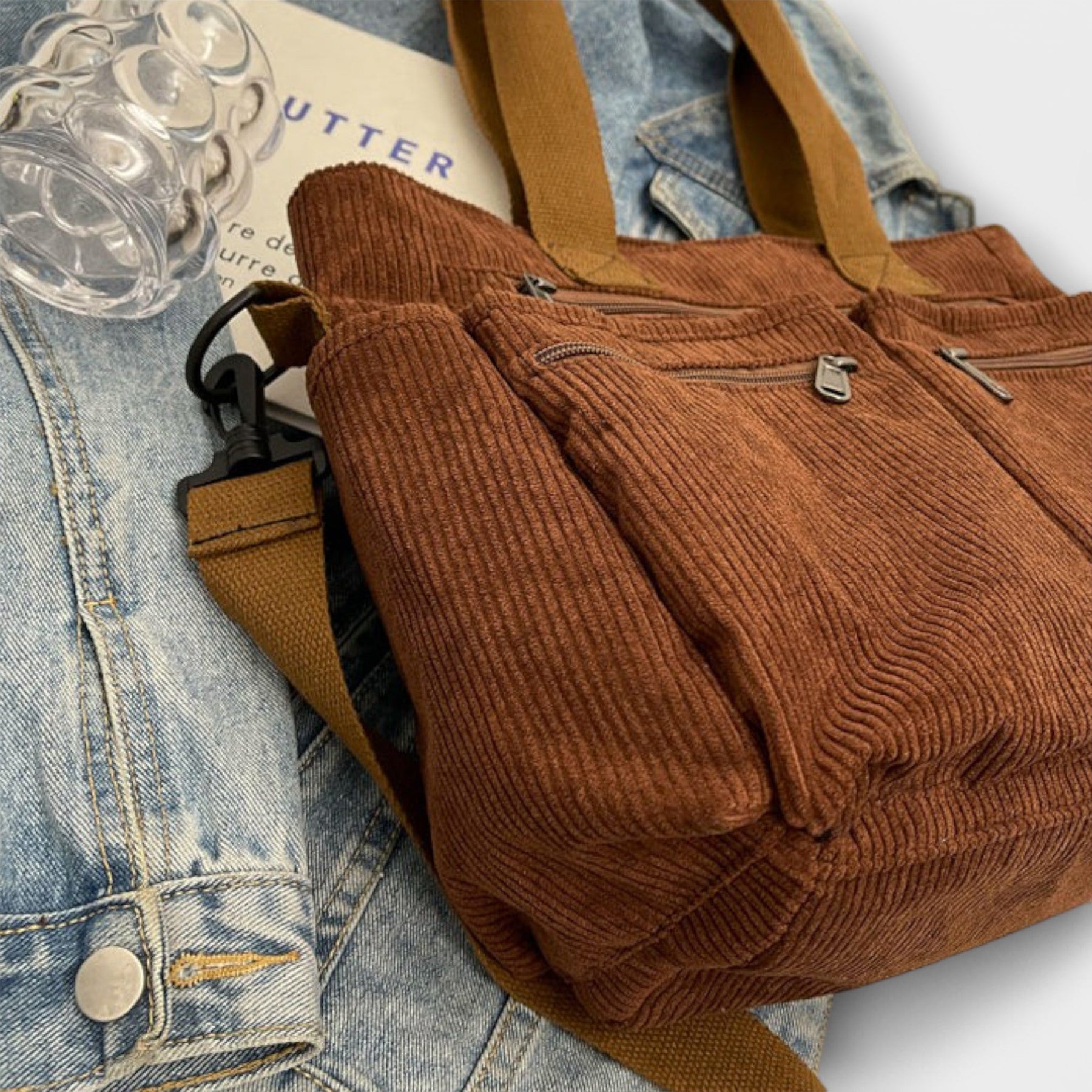 Corduroy tote bag worn as shoulder bag on model