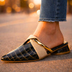 Mule worn on foot, showing pointed toe and open-back design