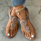 Close-up of beaded and rhinestone circular motif on sandal upper