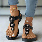 Side profile of embellished toe post sandal showing slingback design