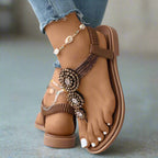 Model wearing embellished toe post sandal, full leg shot outdoors