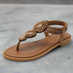 Overhead view of embellished toe post sandal showing beaded pattern