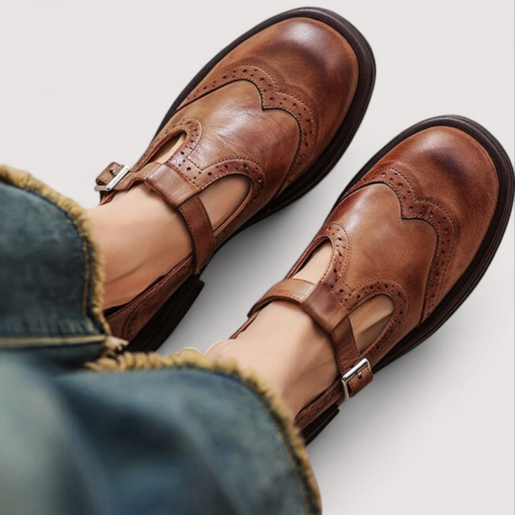 Women's leather brogue Mary Jane sandals with buckle strap, front view