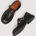 Detail of adjustable buckle strap on leather sandal