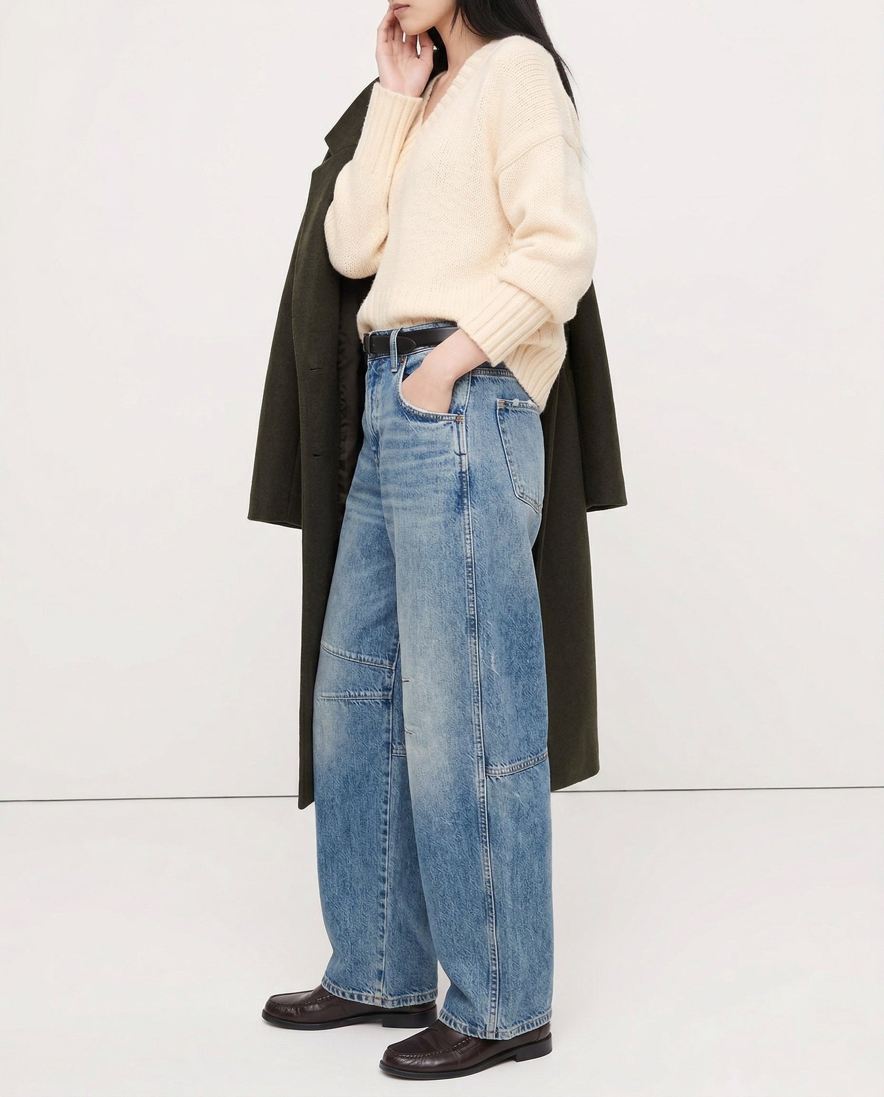Leopard print jeans draped over seated figure, thigh detail