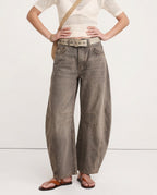 Woman posing from behind in leopard wide leg jeans