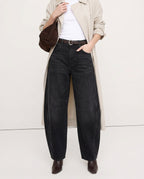 Detail of mid-rise waistband and front pockets on leopard jeans