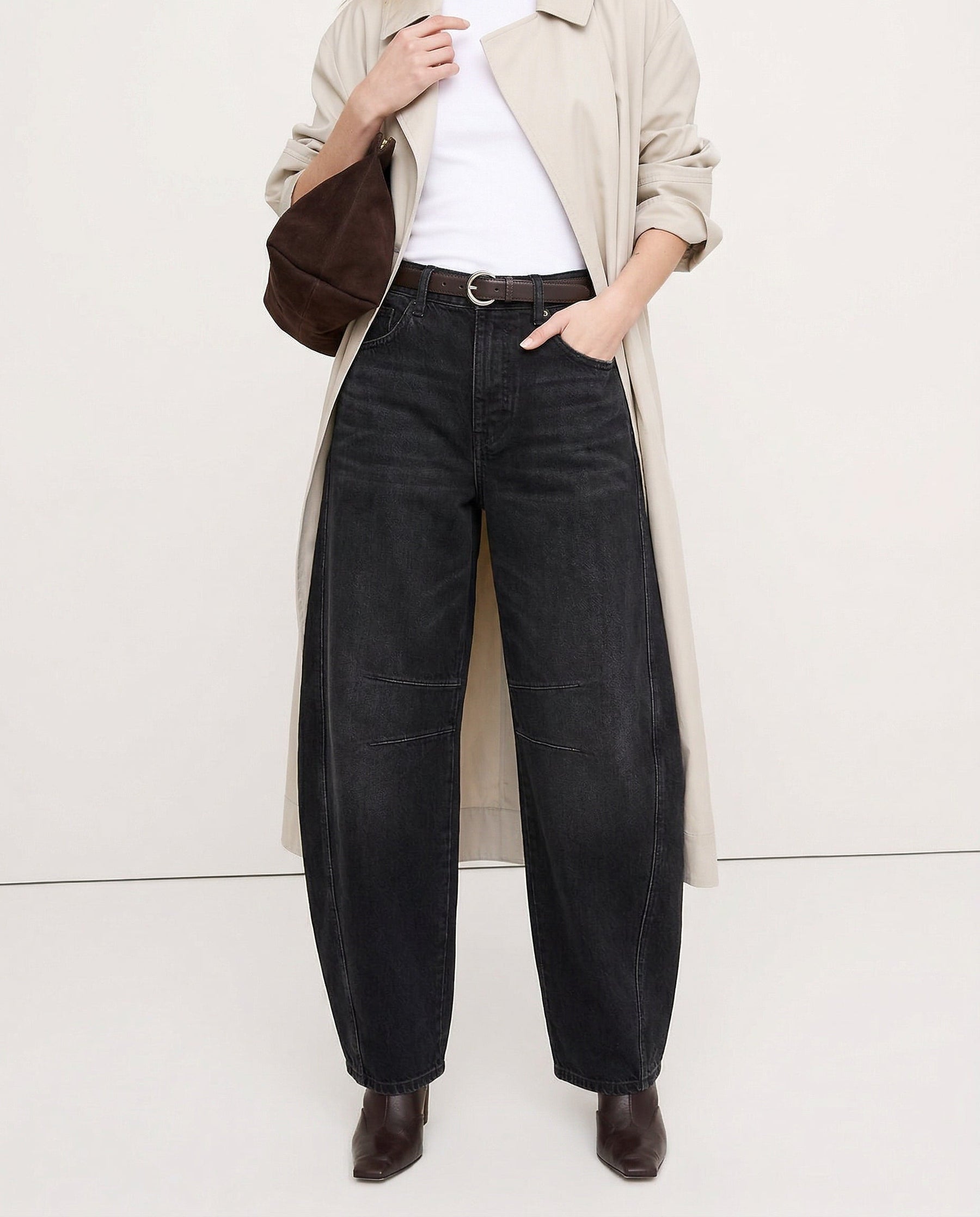 Detail of mid-rise waistband and front pockets on leopard jeans
