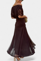 Side profile showing ruched bodice and pleated skirt