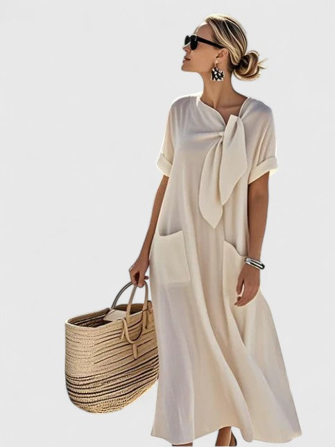 Model wearing tie neck maxi dress, full-length side profile