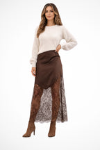 Woman wearing satin lace hem asymmetric maxi skirt, front view