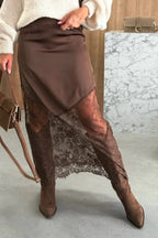 Close-up of semi-sheer lace hem detail on satin skirt