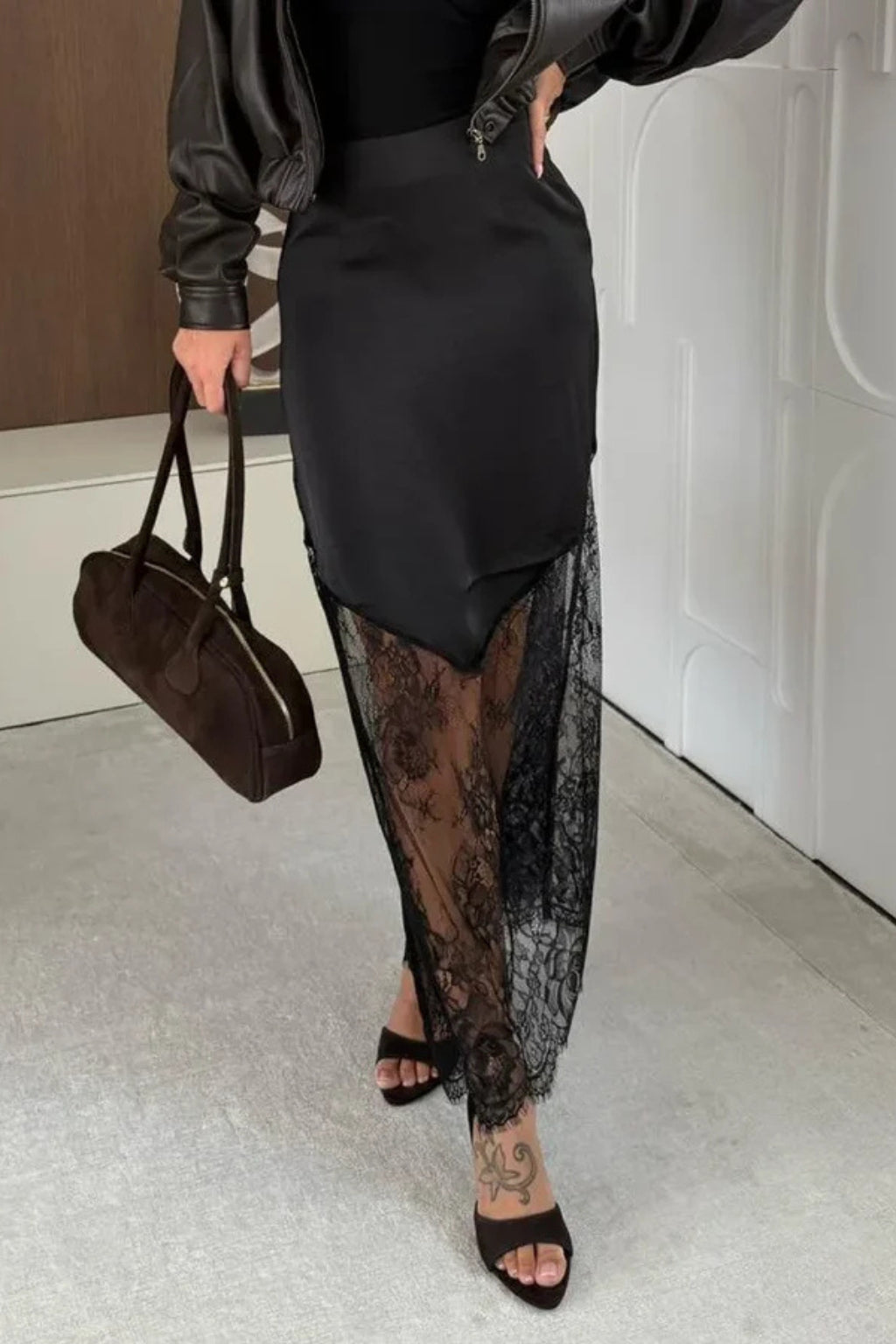Woman standing in asymmetric maxi skirt, angled pose