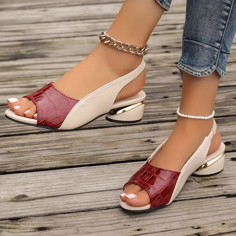 Woman wearing burgundy croc slingback sandals, standing pose