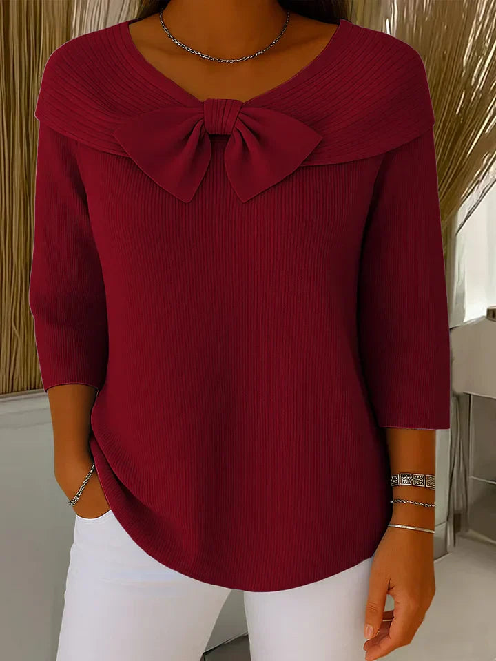 Burgundy ribbed knit top with oversized bow collar, front view