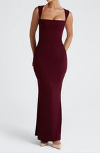 Woman in burgundy maxi dress, angled three-quarter view