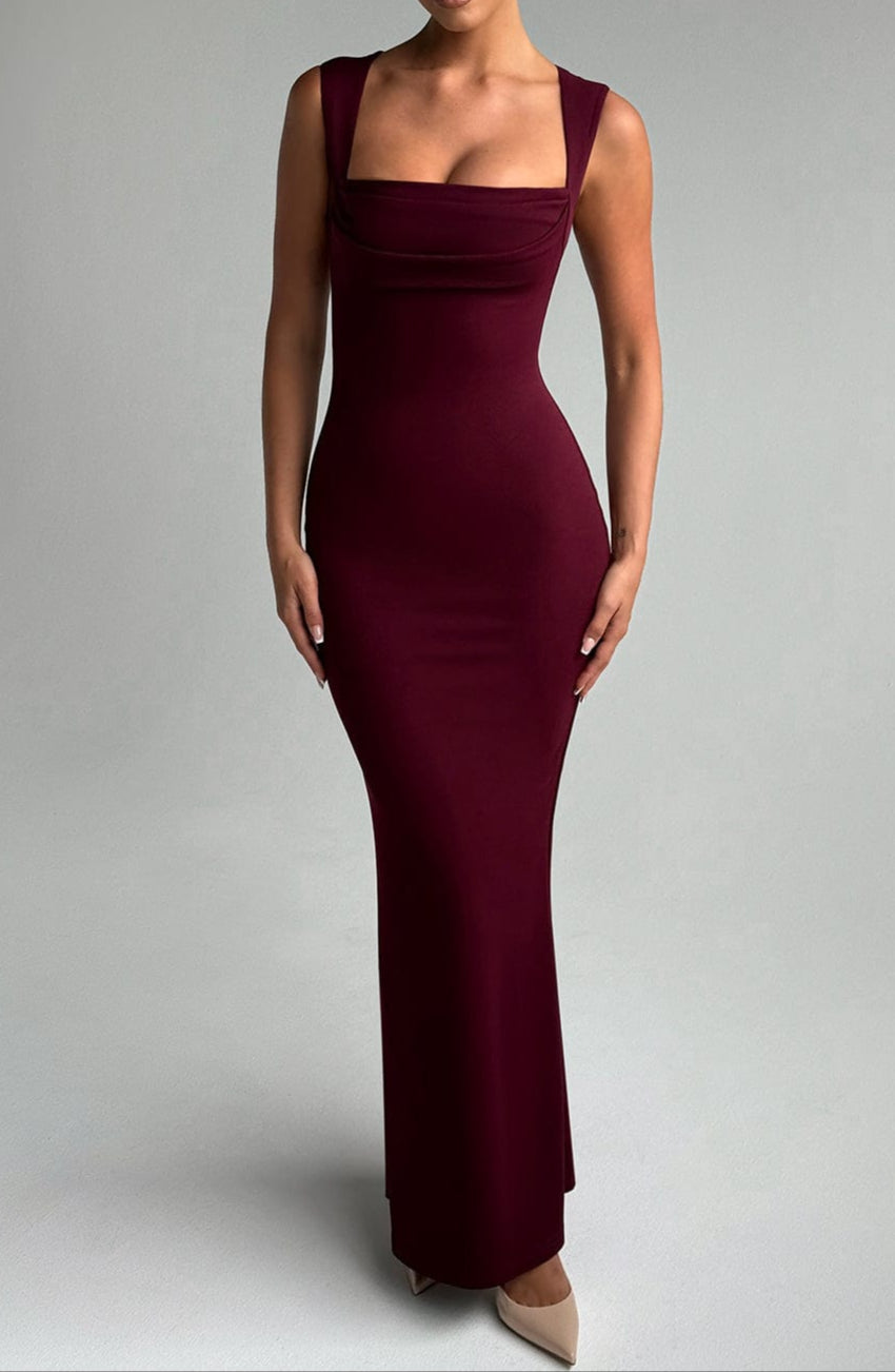 Woman wearing burgundy maxi dress with square neckline, front view