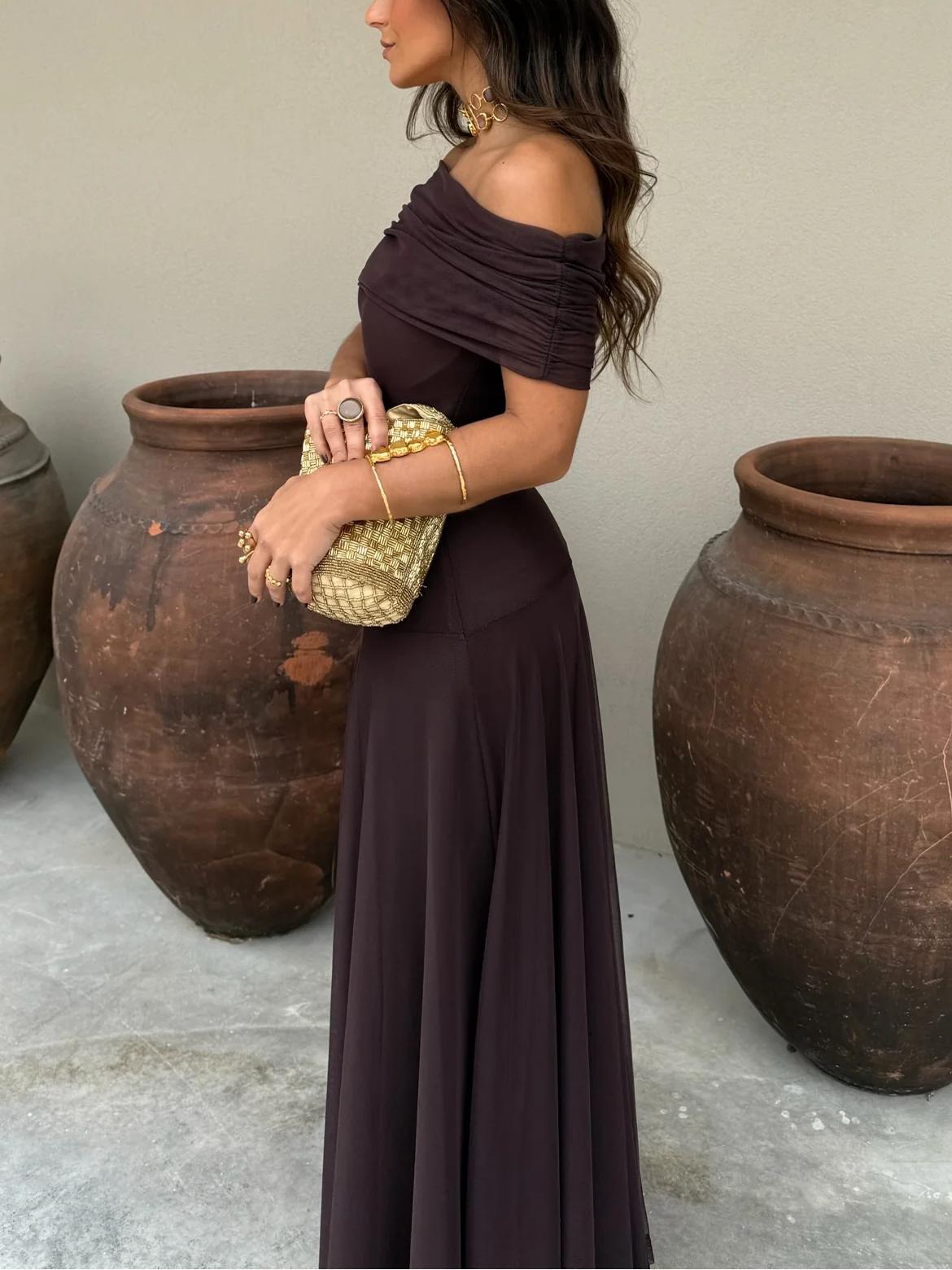 Side profile of maxi dress showing draped chiffon overlay