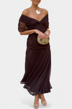 Model wearing off-shoulder dress, side profile pose