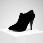 Woman wearing boots, walking pose showing heel and silhouette