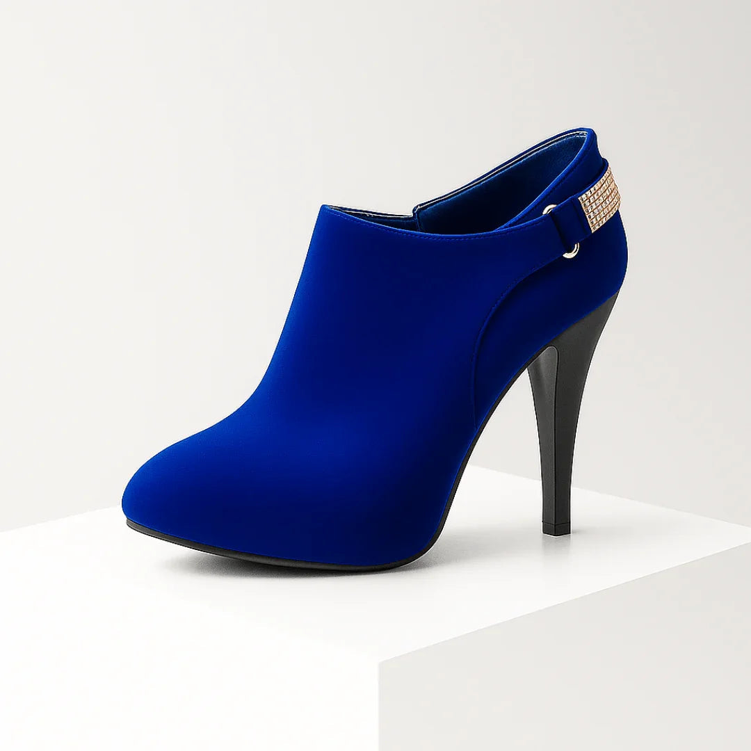 Woman wearing velvet diamante ankle boots, standing pose from front