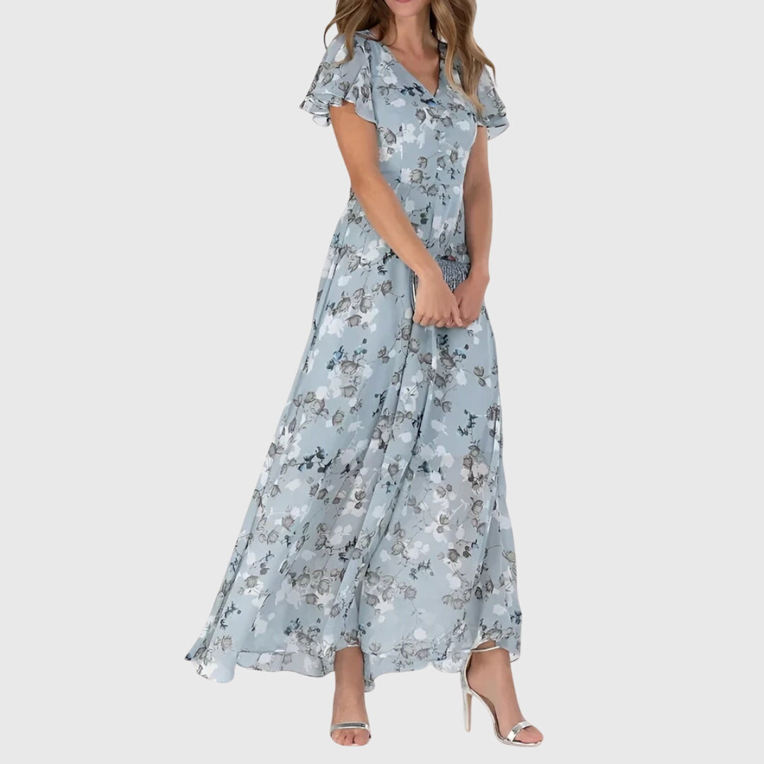 Model wearing floral maxi dress, front-facing pose showing flutter sleeve detail