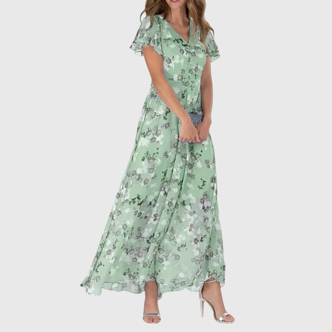 Close-up detail of coral floral print and V-neckline on maxi dress