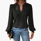 Close-up of intricate lace embroidered panel at V-neckline