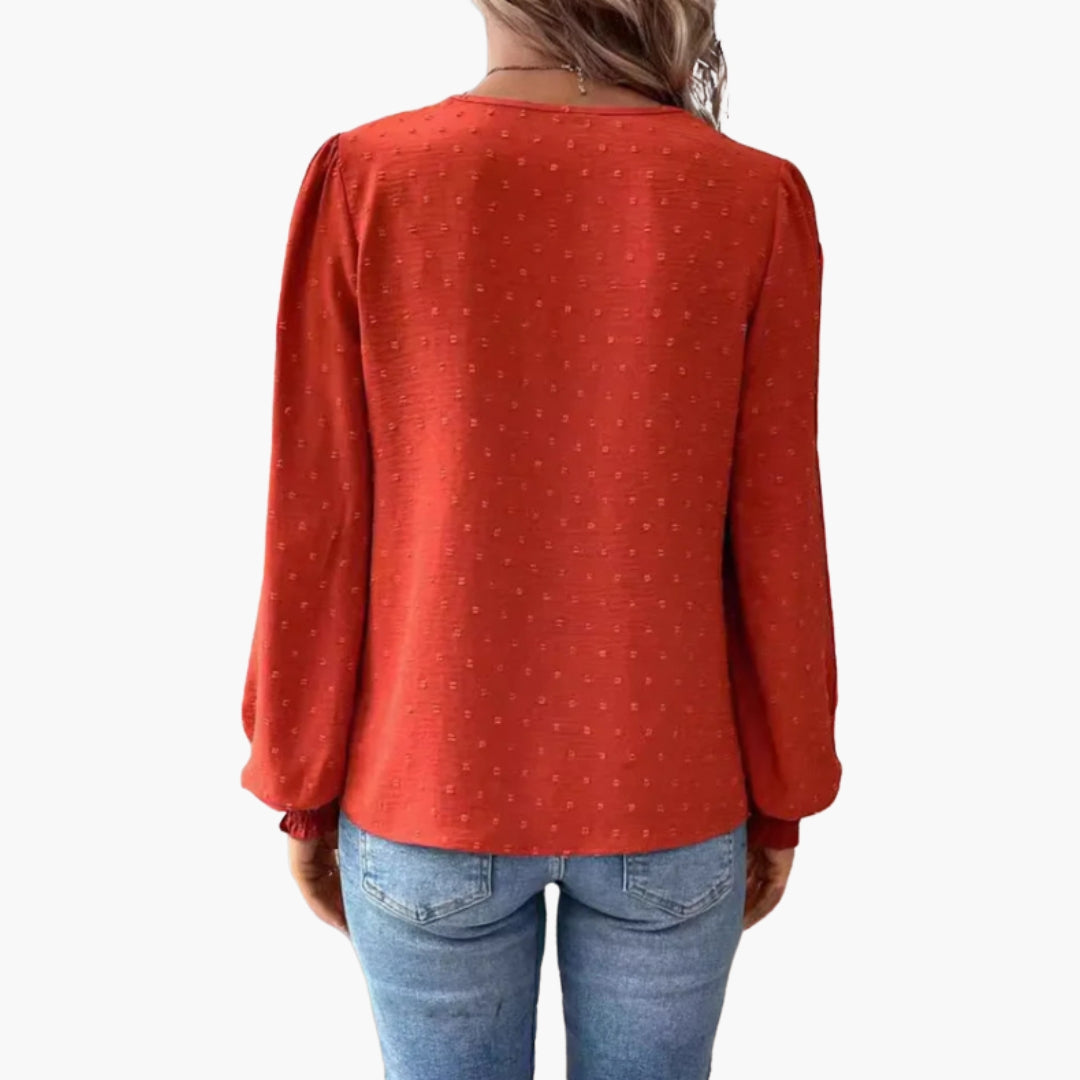 Model in lace trim blouse, side profile showing gathered sleeve cuff