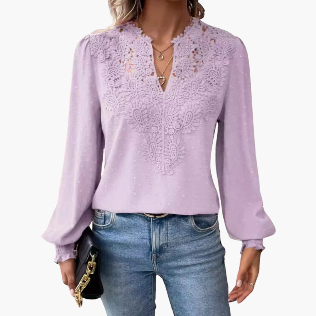 Woman posing in coral blouse, three-quarter angle