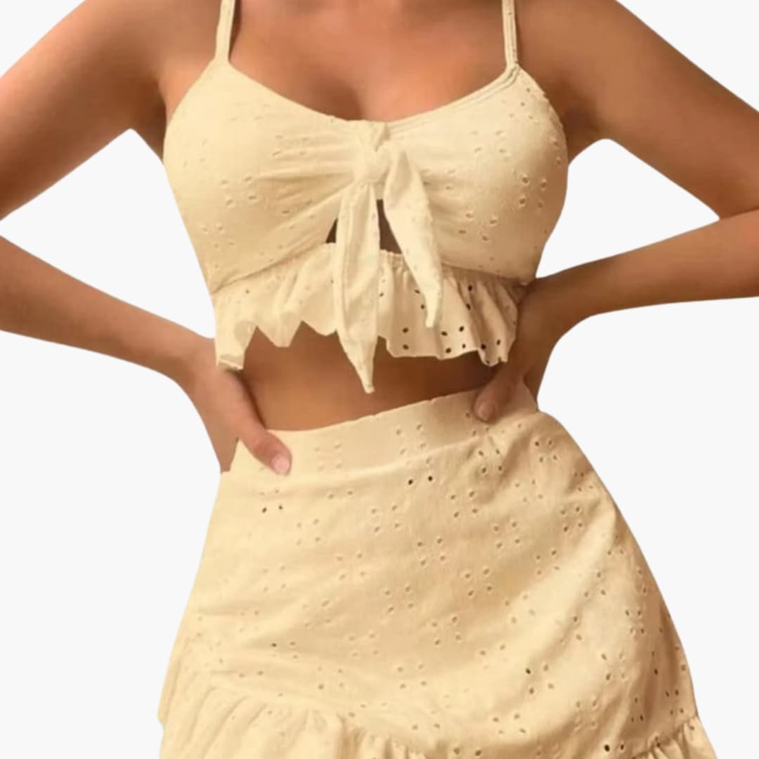 Women's broderie anglaise bikini set with ruffle top and swim skirt, front view