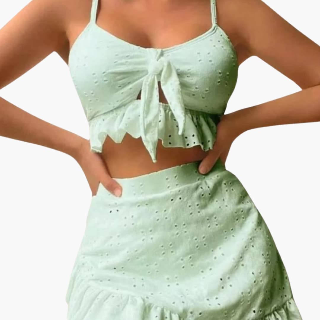 Full-length pose showing complete three-piece set and swim skirt draping