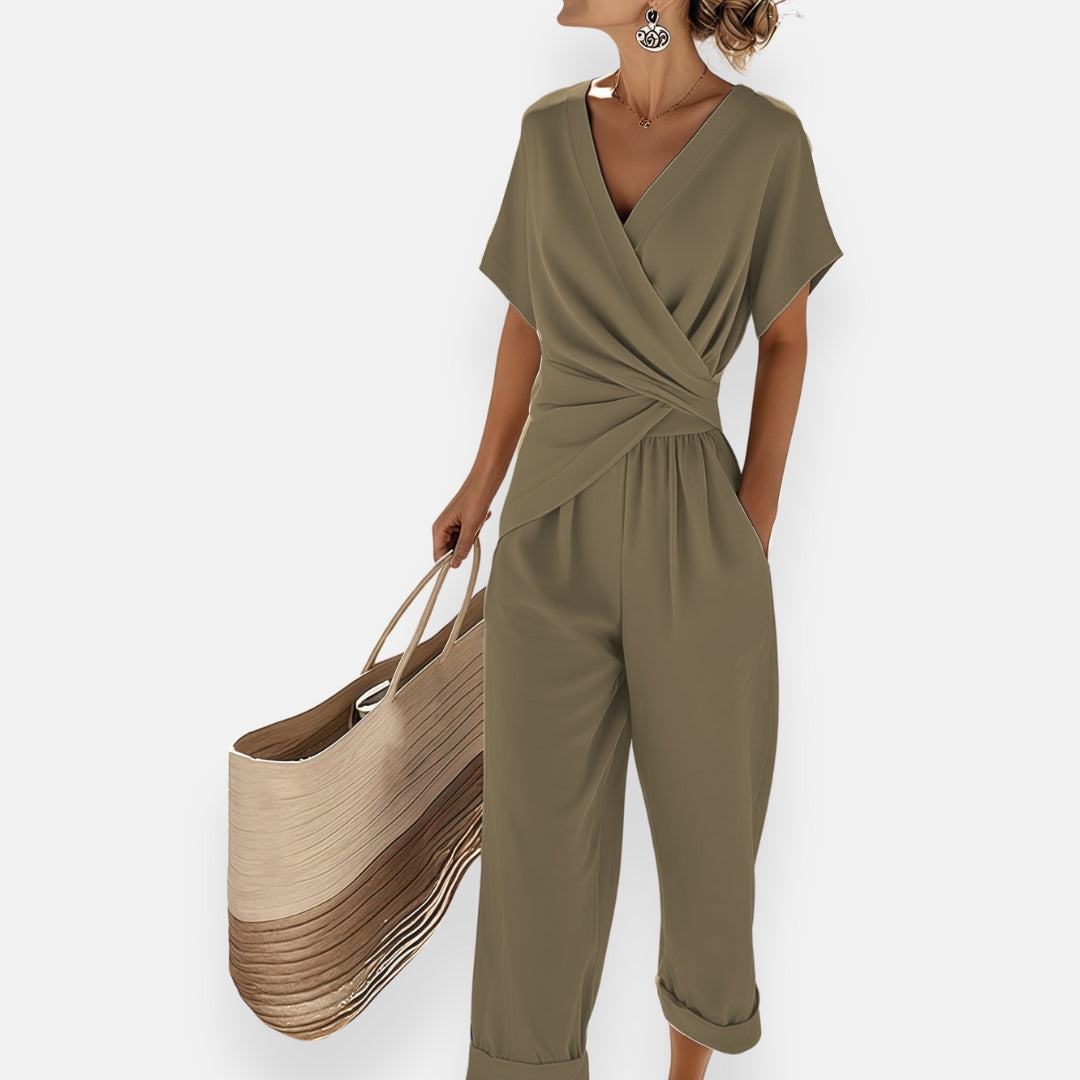 Model wearing jumpsuit with draped wrap front, side angle