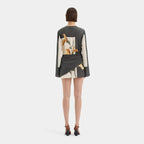 Model wearing terracotta and sage botanical print dress, side angle