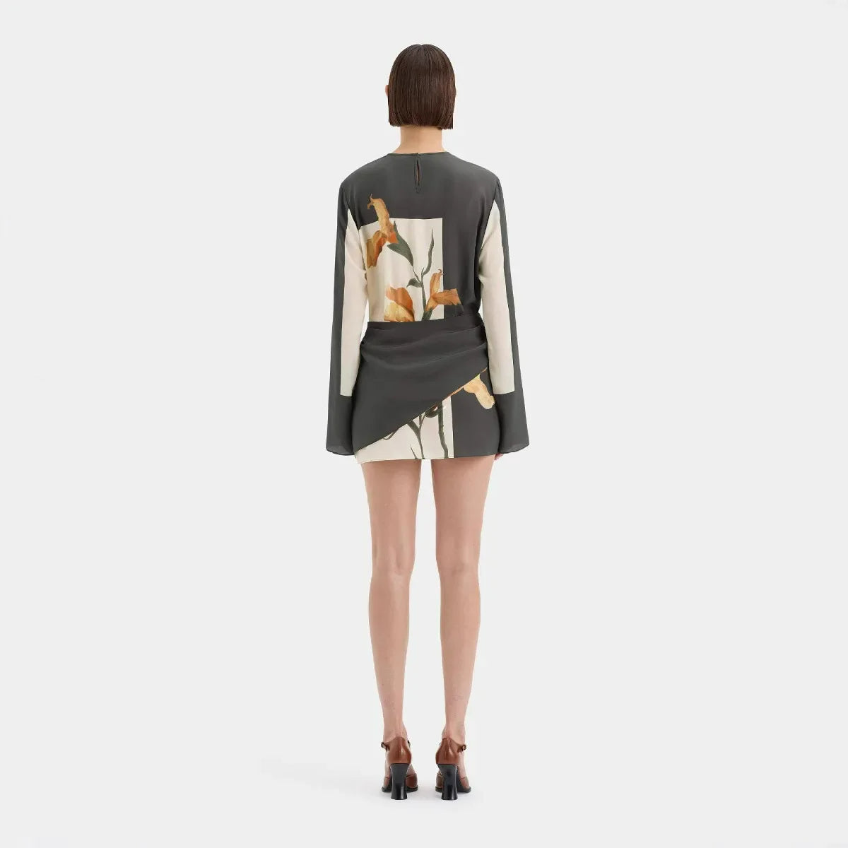 Model wearing terracotta and sage botanical print dress, side angle