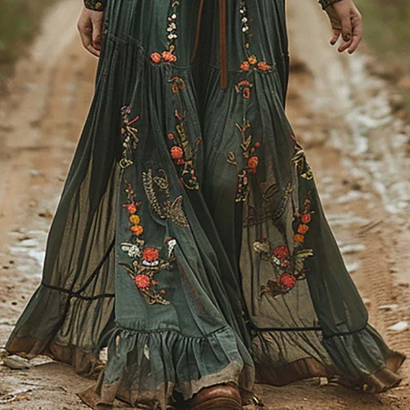 Close-up of intricate floral embroidery and sheer long sleeve