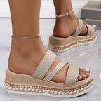 Close-up of glittering gold strap detail on sandal