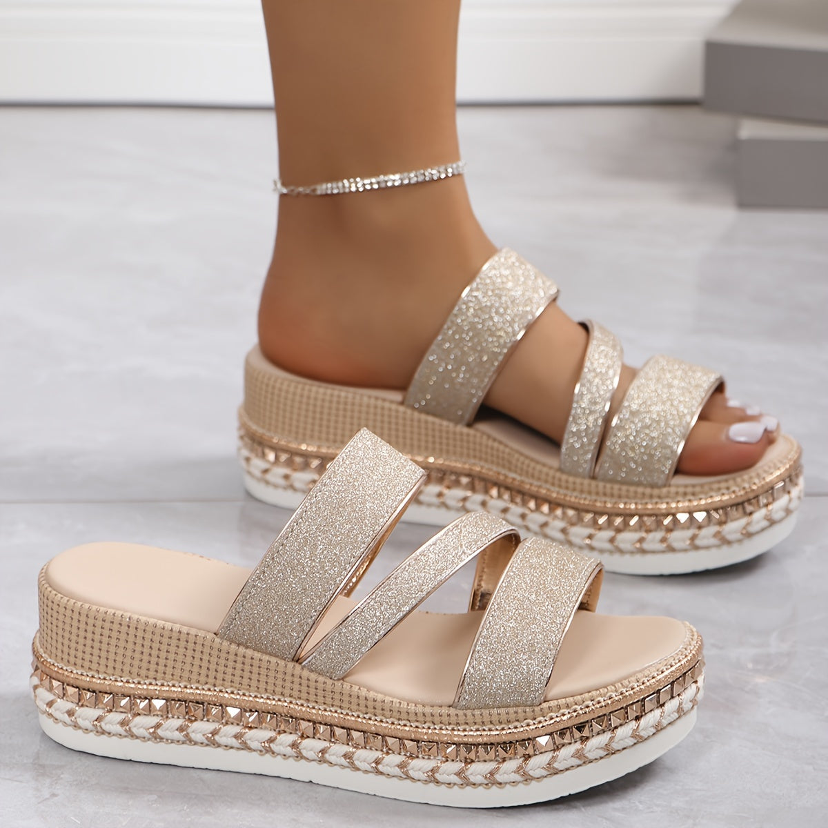 Woman walking in gold glitter flatform sandals, angled shot
