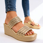 Side profile of metallic wedge sandal showing wedge heel