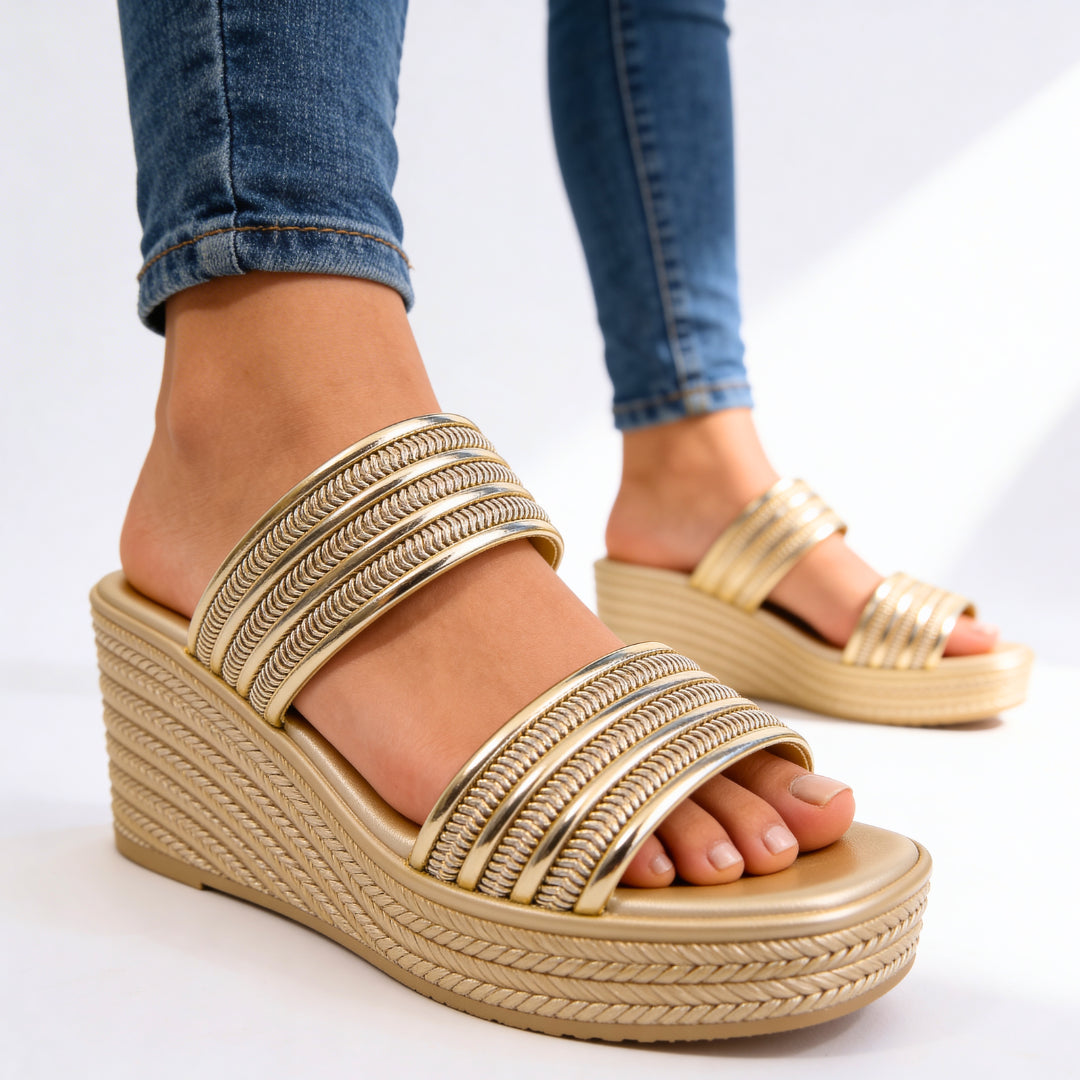 Side profile of metallic wedge sandal showing wedge heel