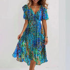 Side profile of wrap midi dress showing asymmetric hemline and silhouette