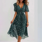 Woman wearing floral chiffon wrap midi dress with flutter sleeves, front view